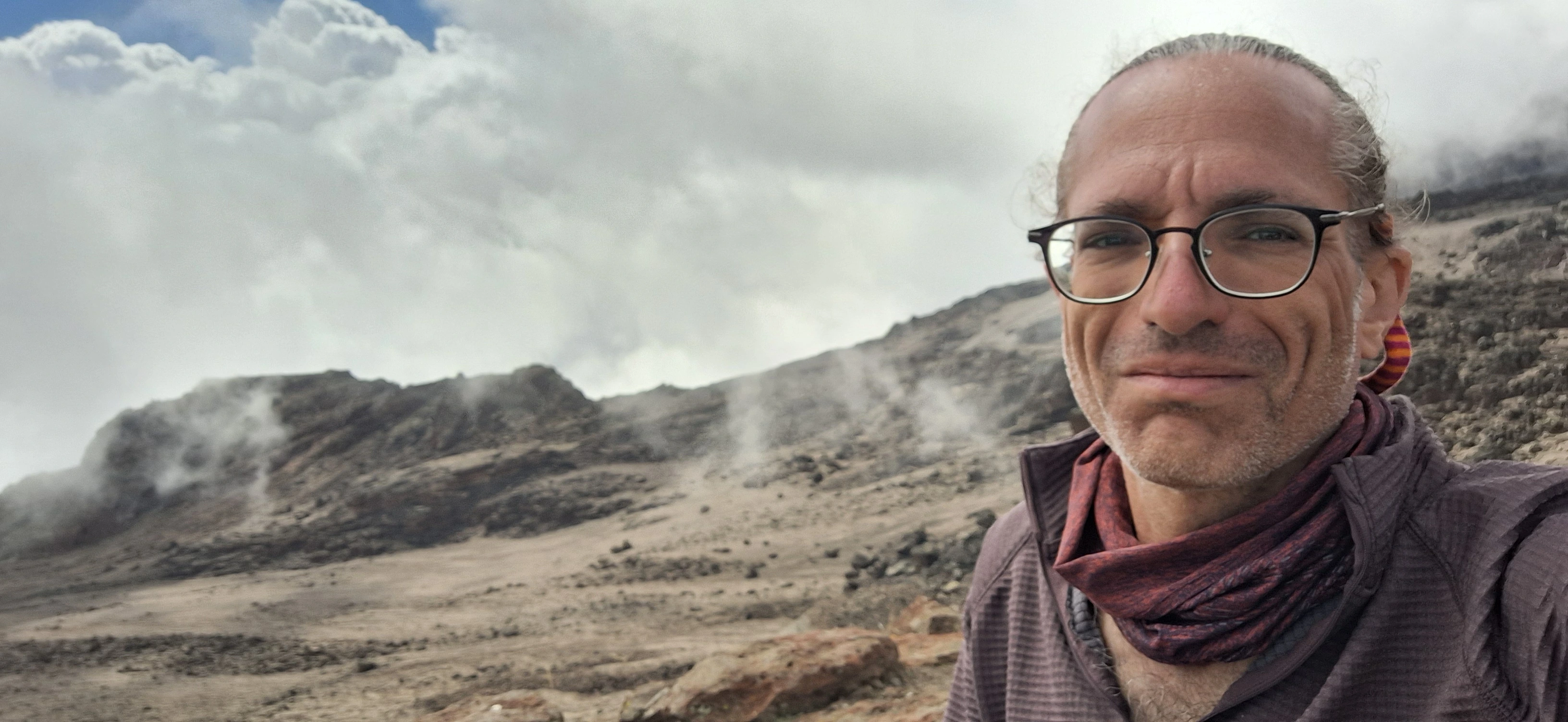 Richard Massel posing during a high-altitude mountain climb on Kilimanjaro.
